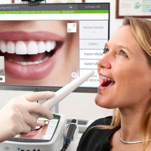 Photo of health professional usinfan Intraoral Dental Camera connected to a Visionflex ProEX Teleheslth Hub and Telehealth Cart